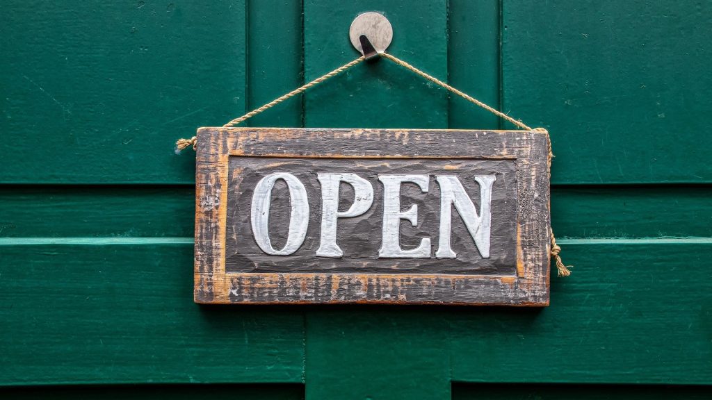 Open sign hanging on a door
